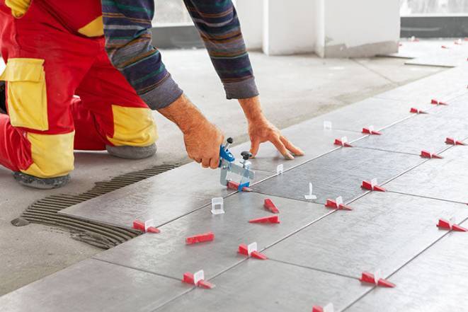 handyman installing-porcelain-tile-